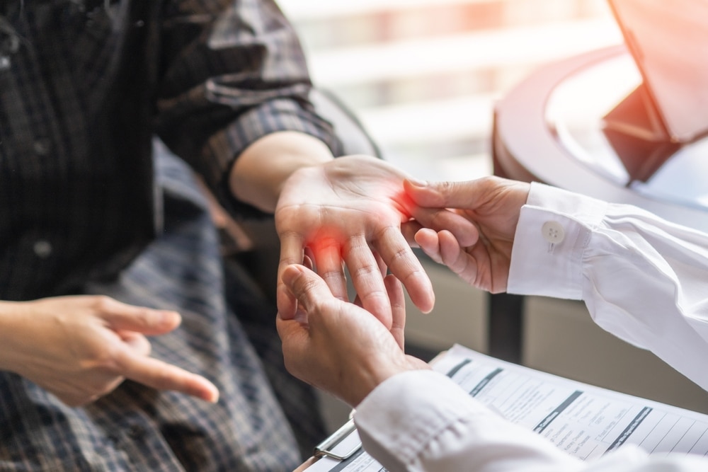 Patient experiencing thumb arthritis symptoms, including joint pain and stiffness, considering surgery for trigger finger and improved hand mobility.